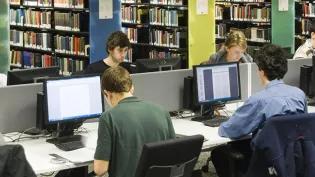 Students working at computers in the library.