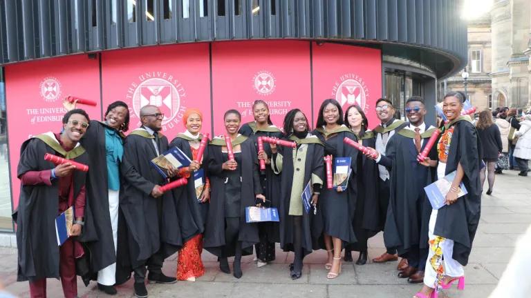 Students standing outside at graduation ceremony.