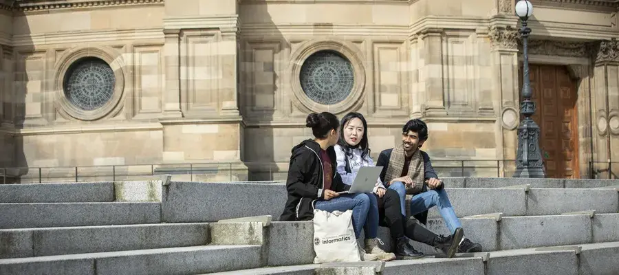 Students chatting on steps outside McEwan Hall.
