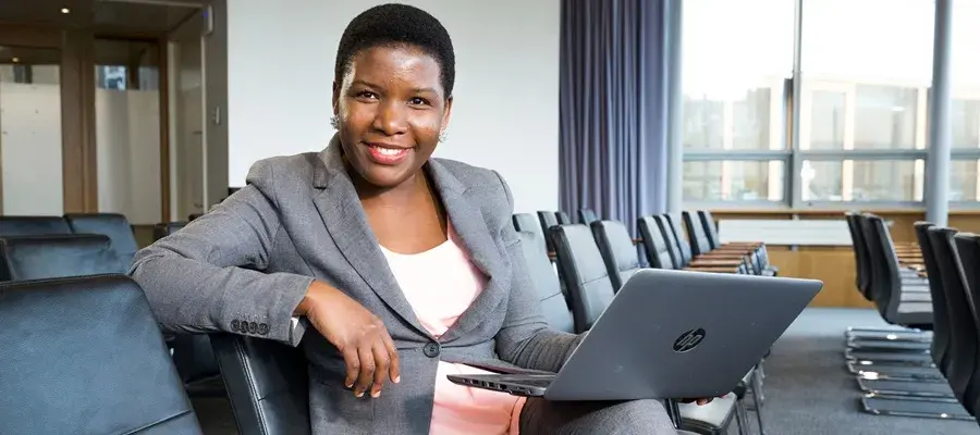 Woman sitting with laptop.