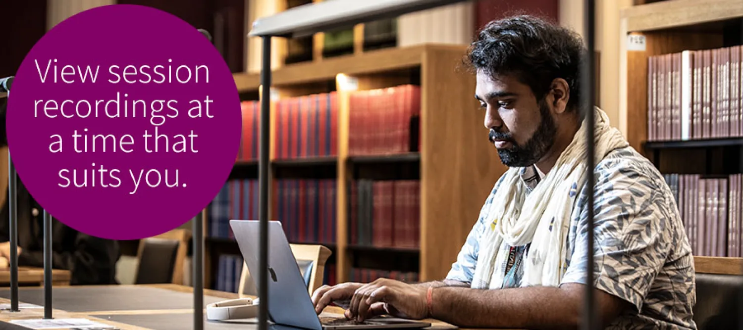 Student looking at laptop in library
