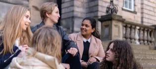 Students chatting on Old College steps.
