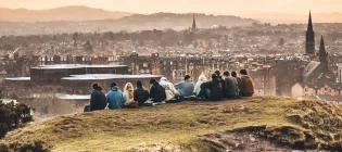 Students sitting on Arthur's Seat looking out to Edinburgh.