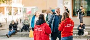 Student ambassadors chatting to student.