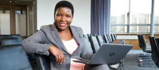 Woman sitting with laptop.