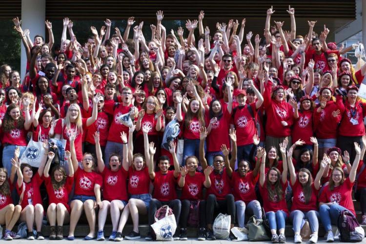 Group photo from a Sutton Trust Summer School graduation. All are wearing red University T-shirts.