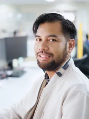Rizky smiles for the camera while in his office