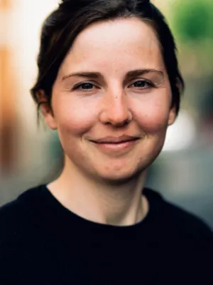 headshot of woman looking directly at camera against a blurred background