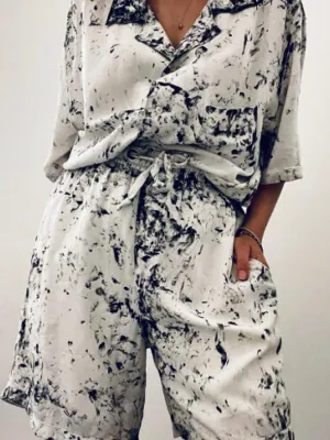 Image of design - shirt and shorts, white with blue speckles