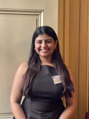 Student smiling at the camera in a University of Edinburgh lecture theatre