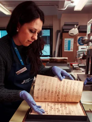 Simona handling book at National Museum of Scotland