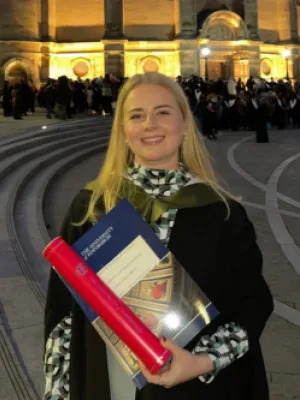Anna Morris standing outside McEwan Hall during her graduation.